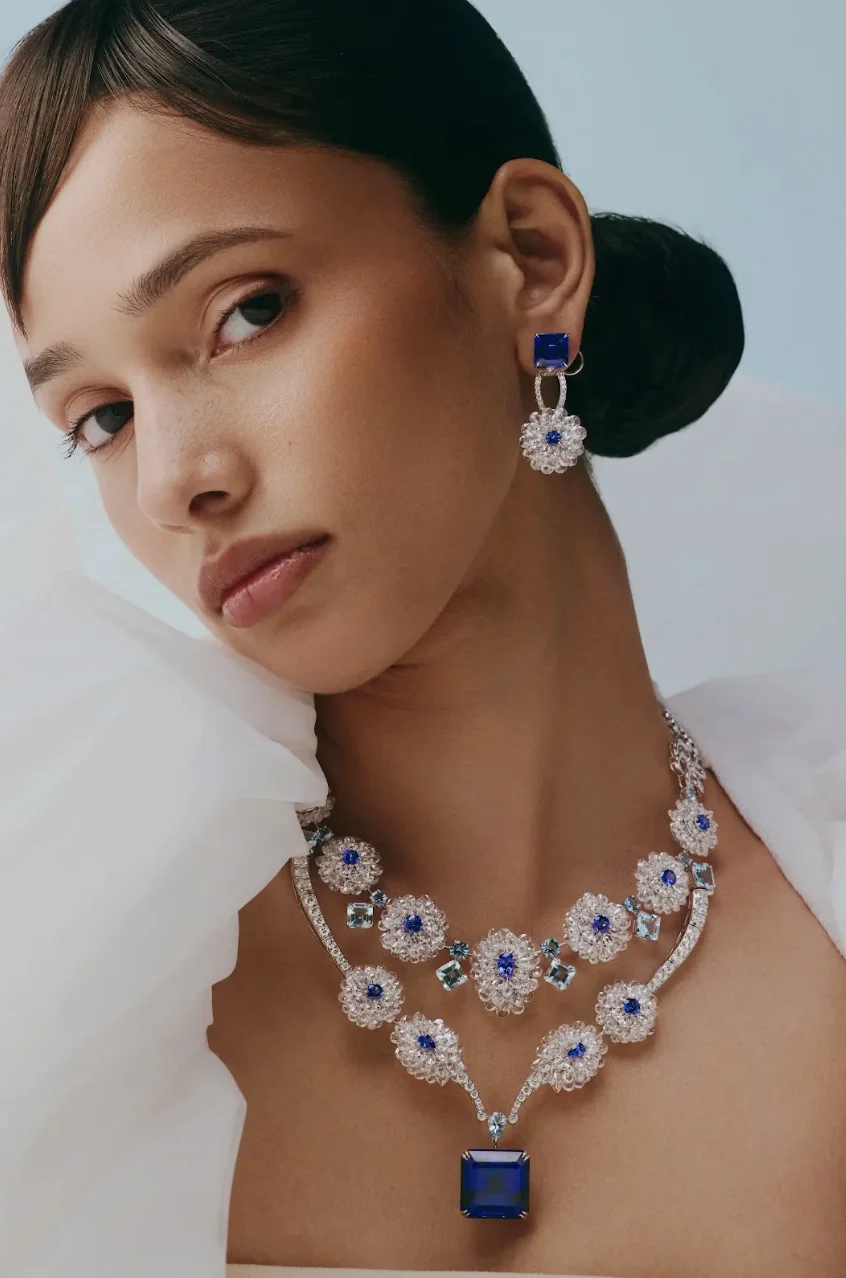 Model wearing a tanzanite, aquamarine and diamond high jewellery necklace and earrings.
